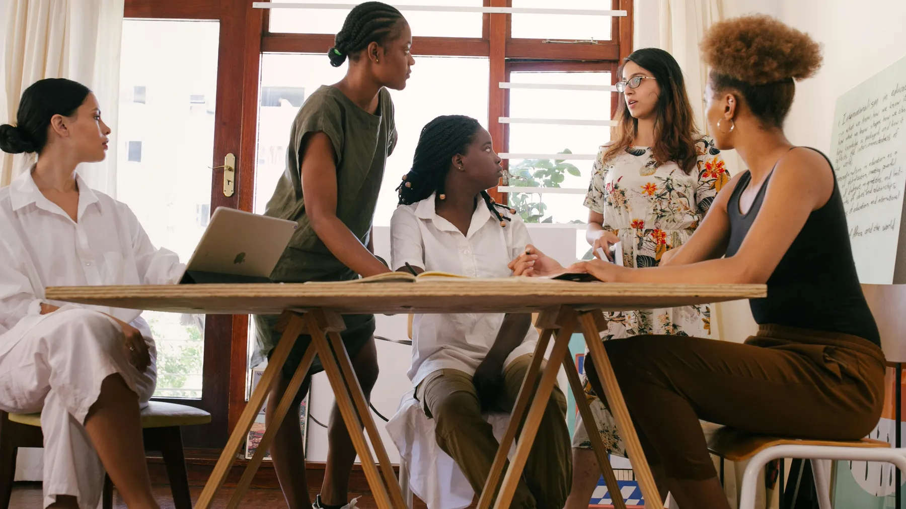 Work mates gathered round discussion